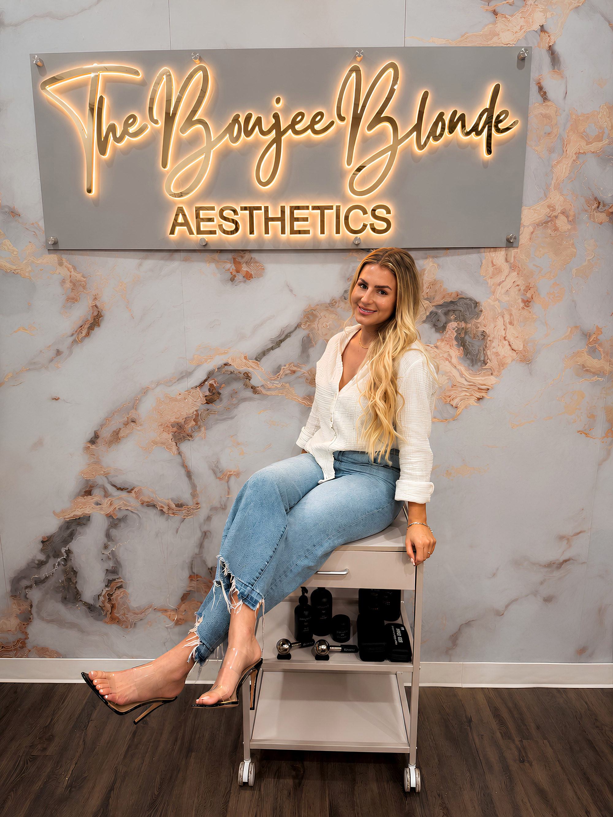 Marissa under The Boujee Blonde Aesthetics neon sign
